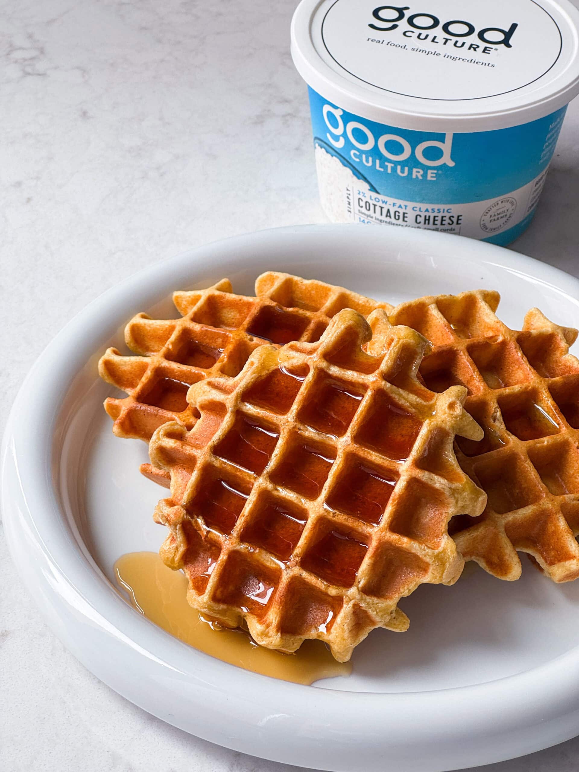 cottage cheese waffle with good culture cottage cheese and syrup on a plate
